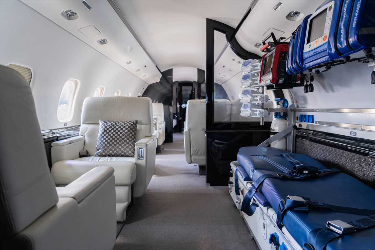 Cabin of a long-range air ambulance with stretcher, monitoring and defibrillator mounted on the bulkhead